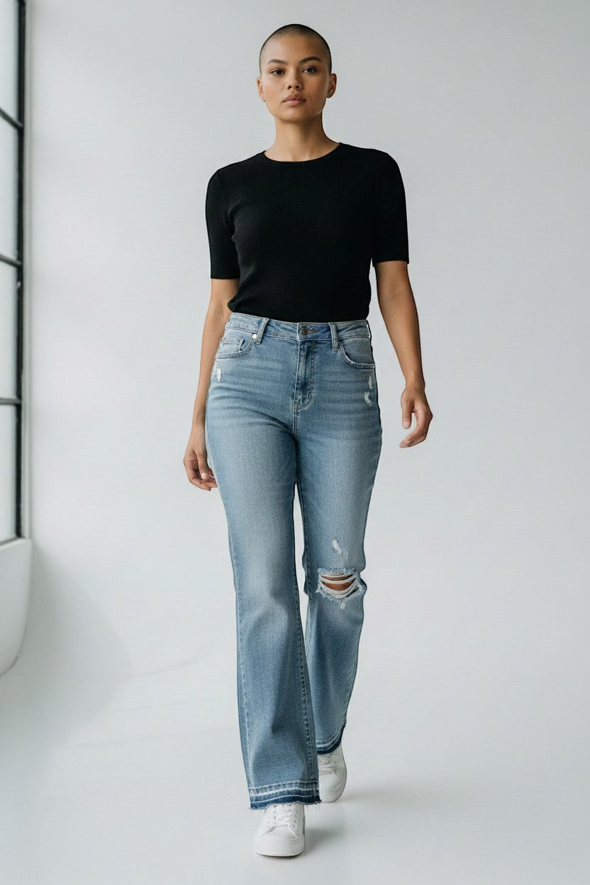Cali's Closet Boutique Judy Blue distressed medium blue bootcut jeans with mid-rise waist and frayed hem.