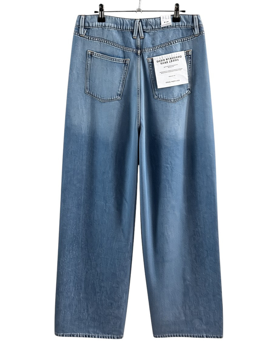 Cali's Closet Boutique light wash denim mid rise relaxed fit jeans with a wide leg and distressed hem.